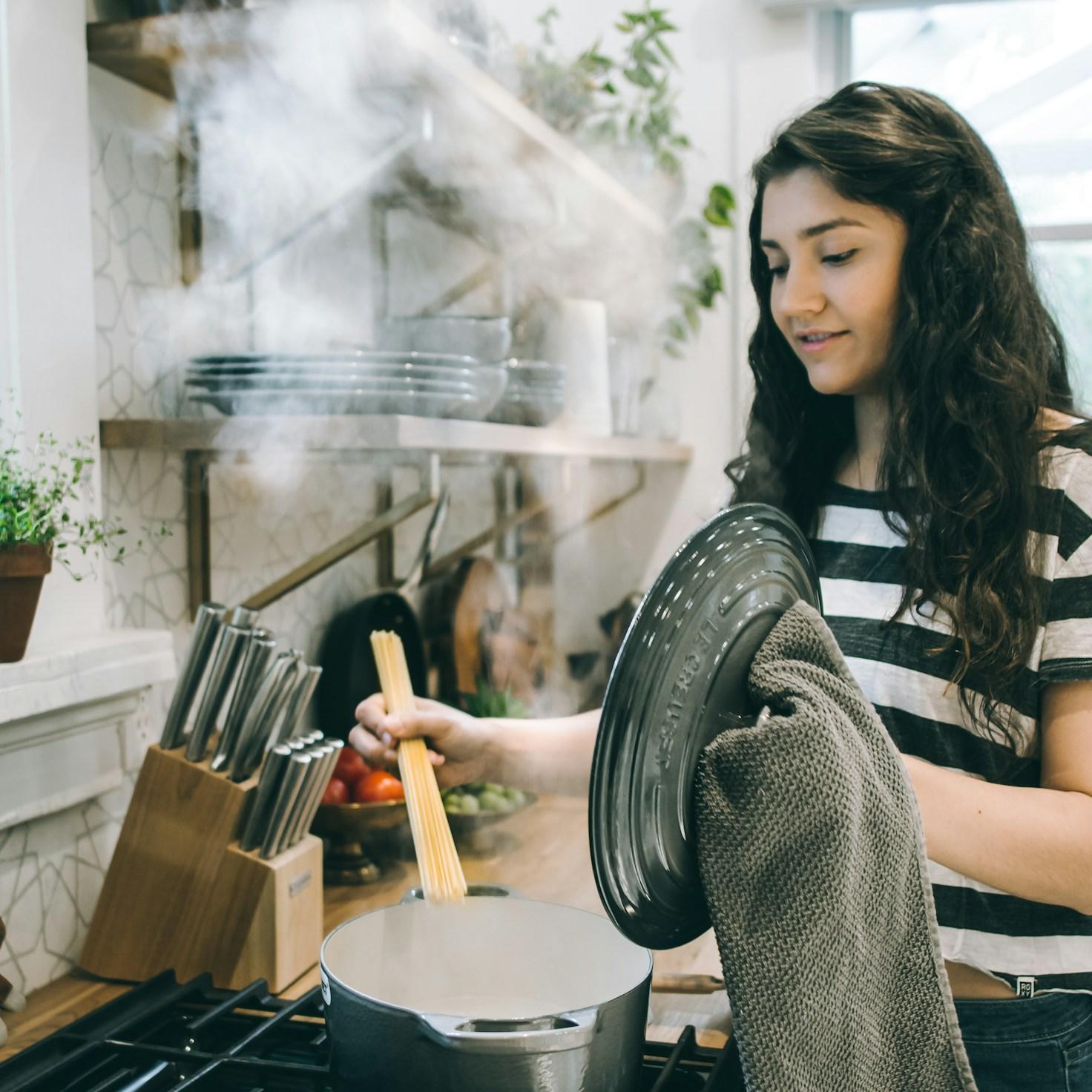 Community members collaborating in a modern kitchen space, sharing recipes and cooking techniques